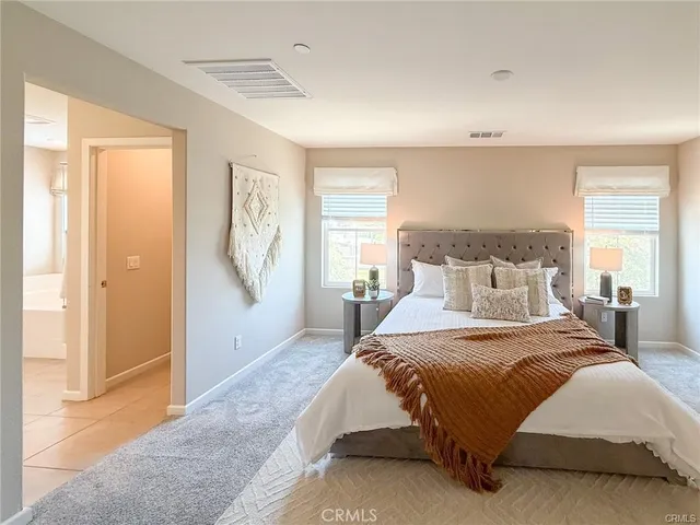 a bathroom with double vanity sinks and a mirror