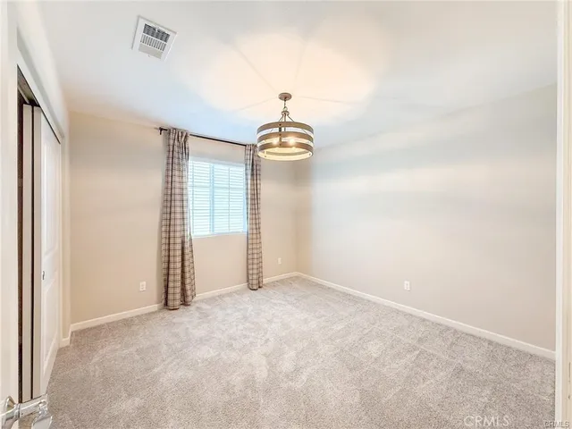 a view of a patio with table and chairs potted plants