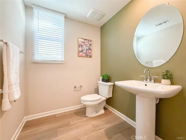 a kitchen with kitchen island a white counter top space a refrigerator a sink and a stove