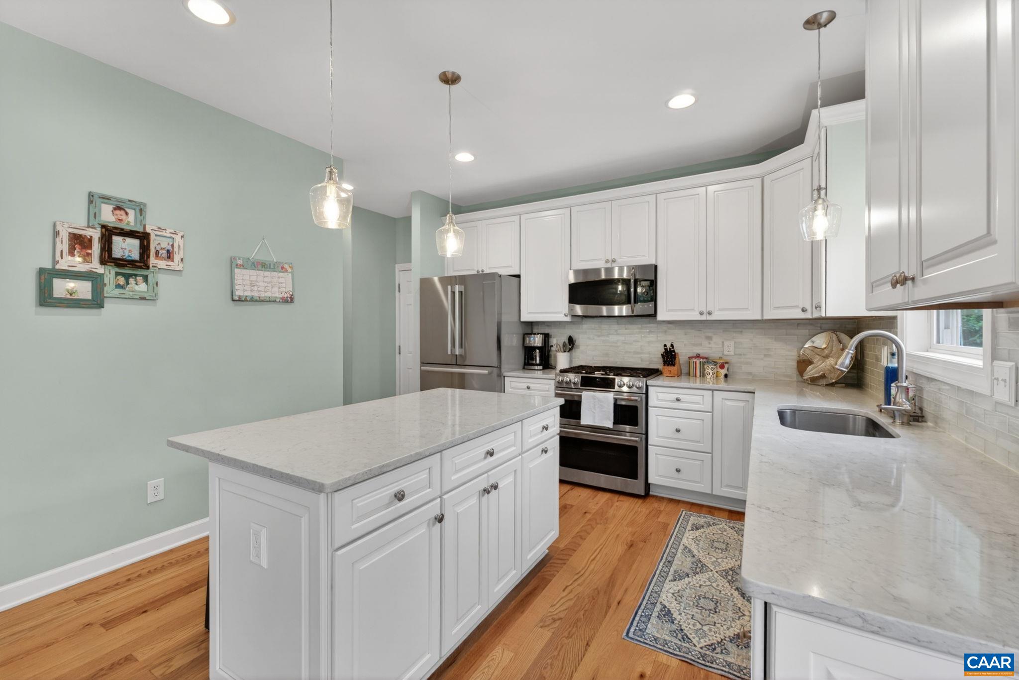511 Taylor Ridge Way Palmyra, VA 22963 - Photo 18 of 57 a kitchen with white cabinets and stainless steel appliances