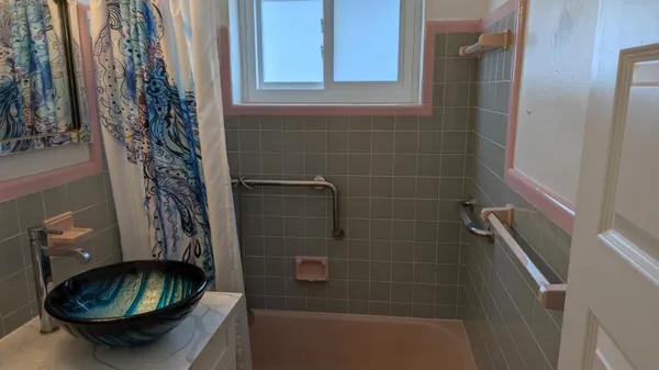 a bathroom with a sink a toilet and a mirror