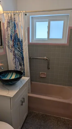 a bathroom with a bathtub and a shower