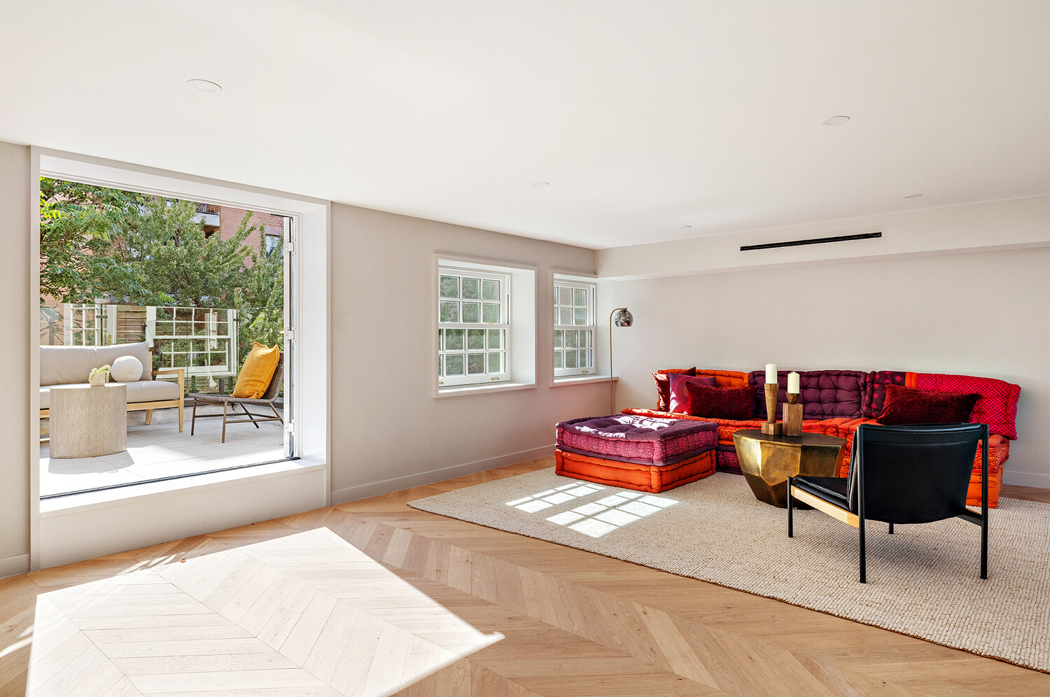 436 West 20th Street Manhattan, NY 10011 - Photo 18 of 24 a living room with furniture and a window