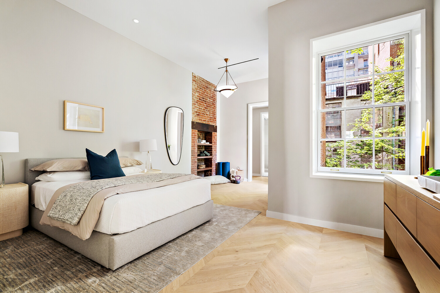436 West 20th Street Manhattan, NY 10011 - Photo 21 of 24 a spacious bedroom with a large bed and a window