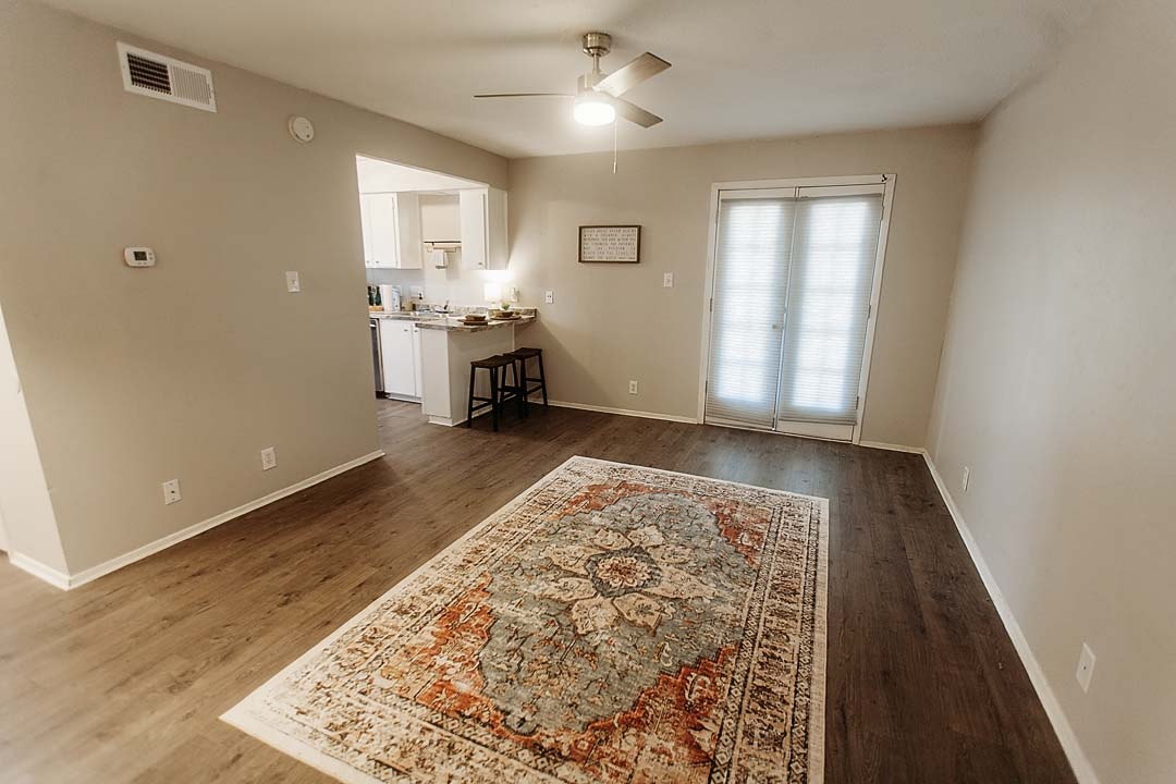 3712 Menchaca Road, Unit 7 Austin, TX 78704 - Photo 13 of 13 An open floor plan connects the living area to the kitchen featuring wood-inspired flooring.