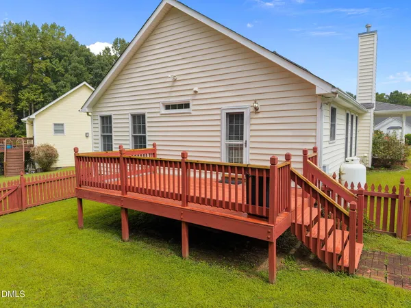 a view of a deck with a bench and a yard