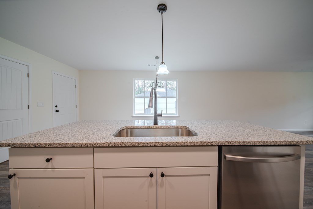 4396 Forrest Road Columbus, GA 31907 - Photo 12 of 24 a kitchen with granite countertop white cabinets and a sink