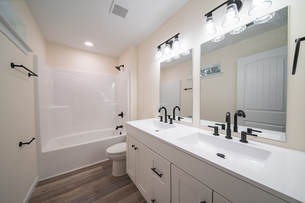 4396 Forrest Road Columbus, GA 31907 - Photo 16 of 24 a bathroom with a double vanity sink toilet mirror and bathtub