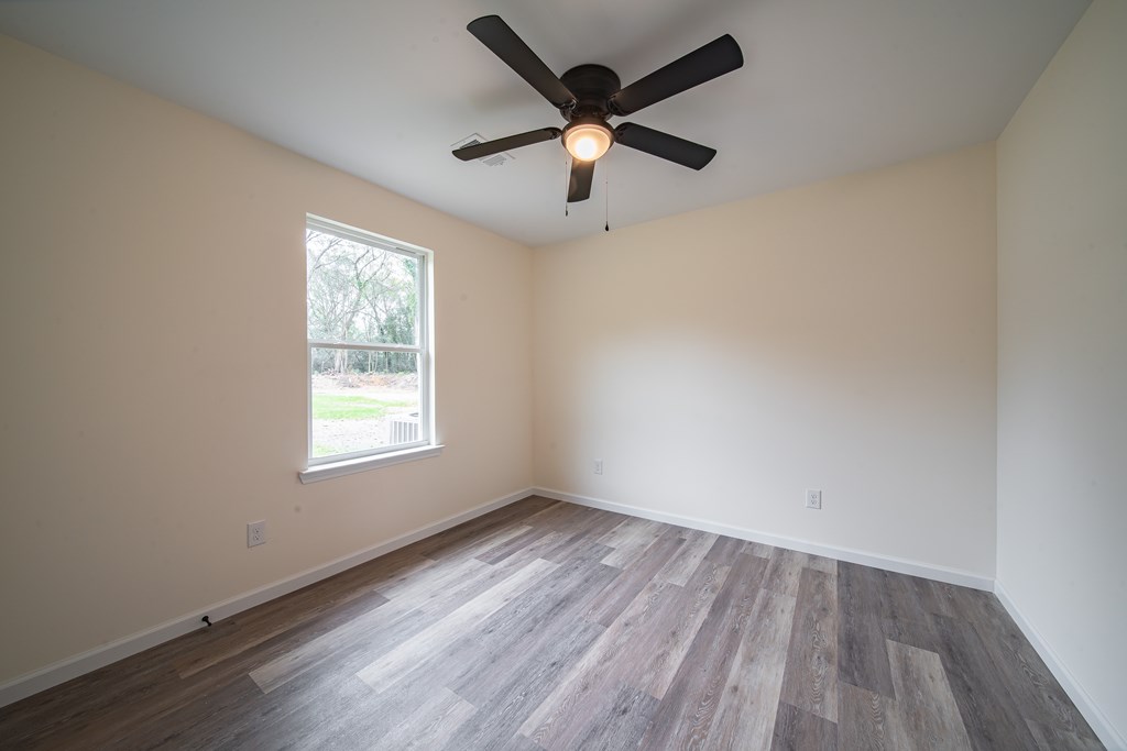 4396 Forrest Road Columbus, GA 31907 - Photo 18 of 24 an empty room with wooden floor and windows