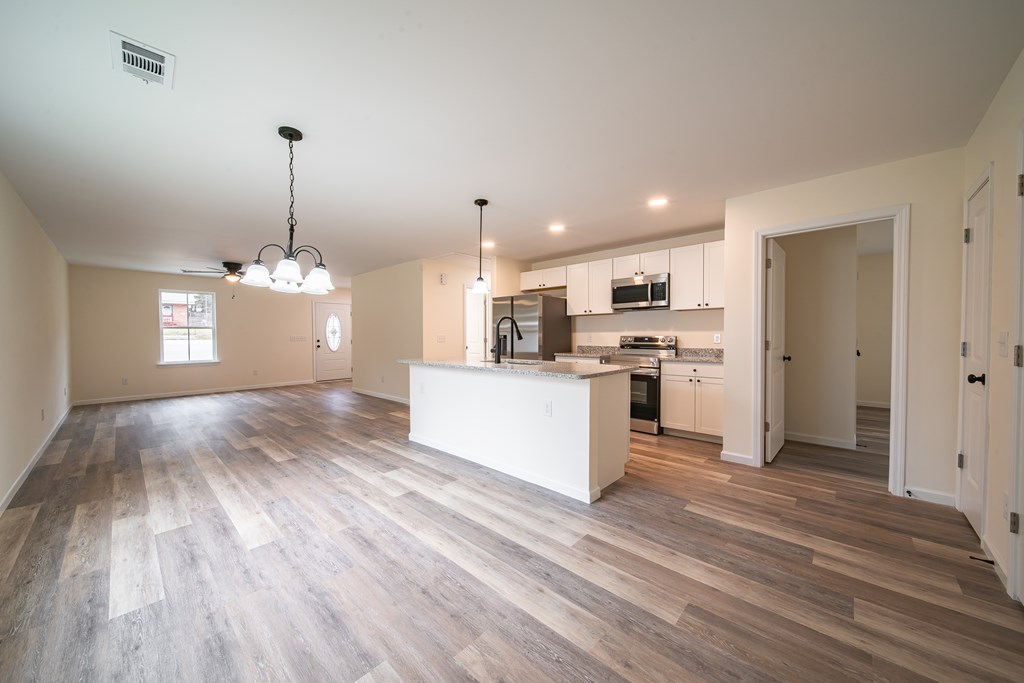 4396 Forrest Road Columbus, GA 31907 - Photo 8 of 24 a view of a kitchen with kitchen island wooden floors stainless steel appliances