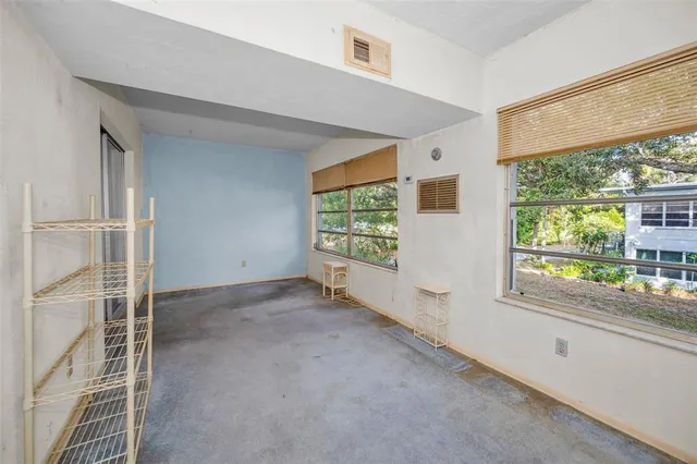 a dining room with lots of furniture and a large window