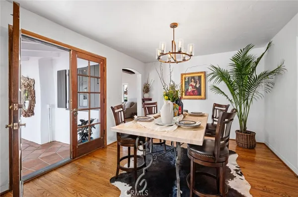 a view of a dining room with furniture wooden floor and chandelier