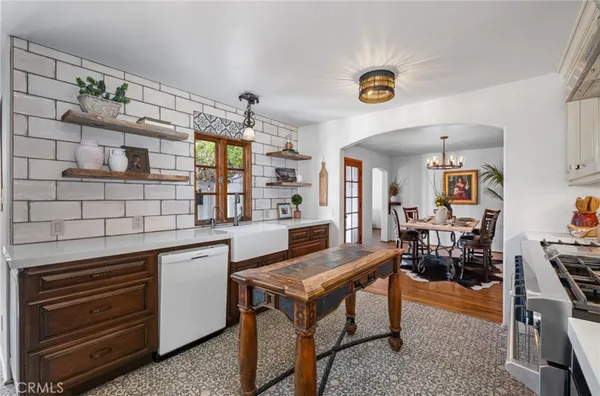 a dining room with furniture a chandelier and wooden floor