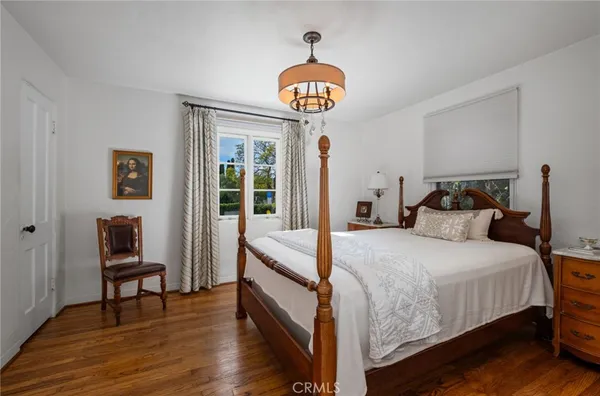 a bedroom with a large bed and a large window