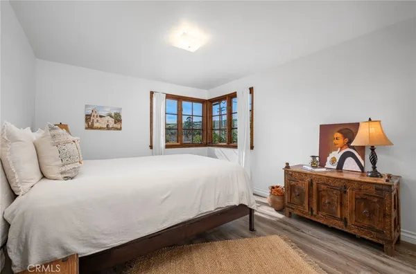 a bed sitting in a bedroom next to a lamp