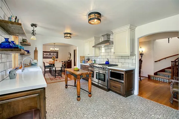 a living room with stainless steel appliances kitchen island granite countertop furniture and a kitchen view