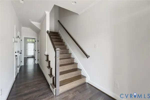 a view of a hallway with wooden floor and entryway