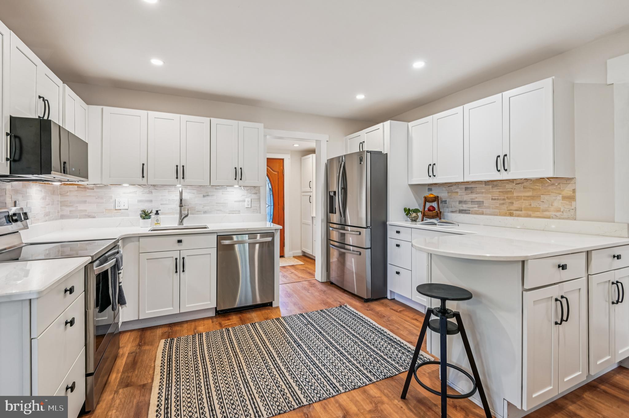 415 Londontown Road Edgewater, MD 21037 - Photo 16 of 51 a kitchen with white cabinets and white appliances
