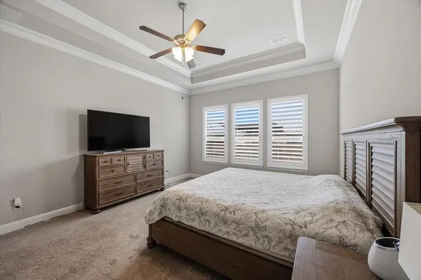 a bedroom with a large bed and a flat screen tv