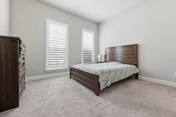 a bedroom with a bed closet and a window