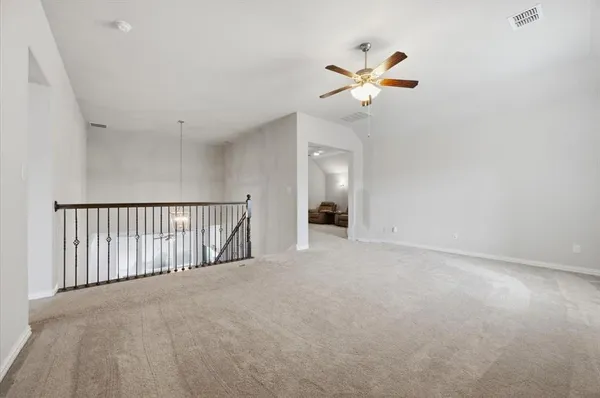 a view of a livingroom with a ceiling fan and window