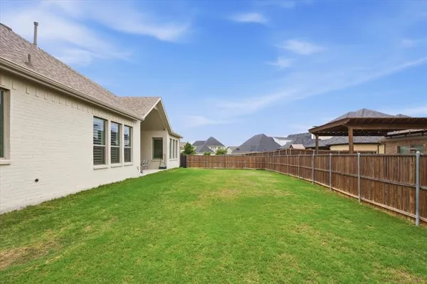a view of backyard of house with green space