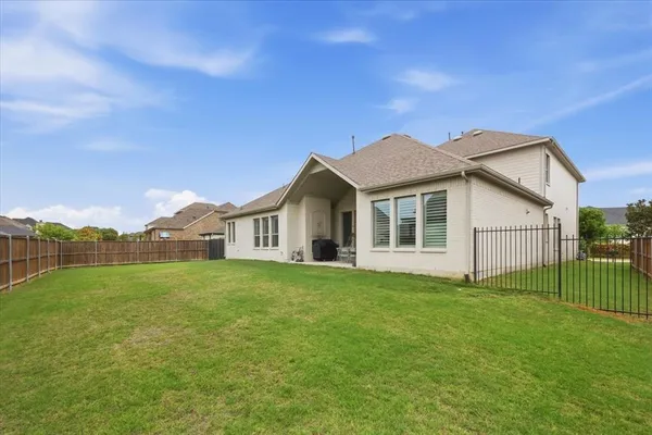 a view of a house with a yard and deck