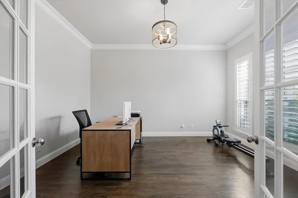 a room with wooden floor and windows