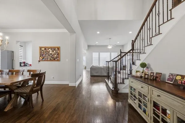 a dining room with furniture entryway and wooden floor