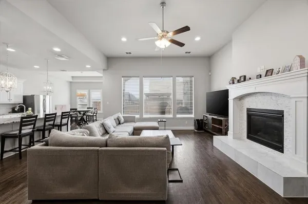a living room with furniture a fireplace and a flat screen tv