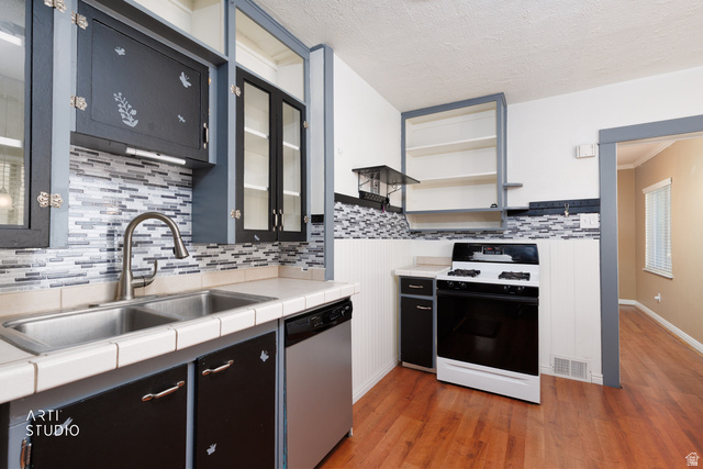 146 West 200 N Street Springville, UT 84663 - Photo 11 of 29 Kitchen featuring a mosaic tile backsplash, double basin stainless steel sink with a gooseneck faucet, white tile countertops, and a white gas range