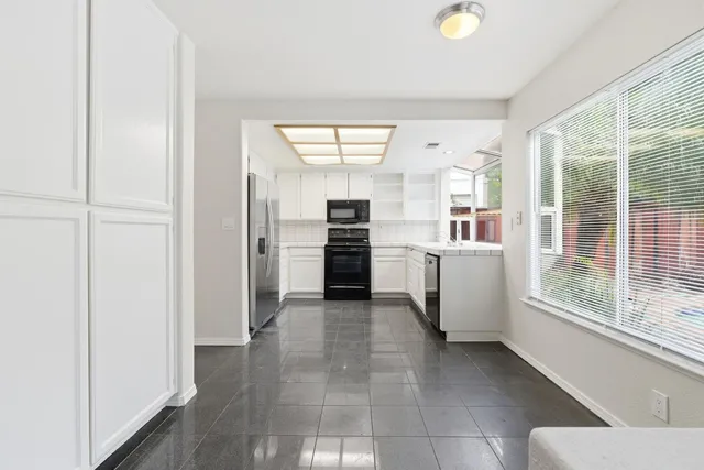 a view of a kitchen with an entryway and a stove