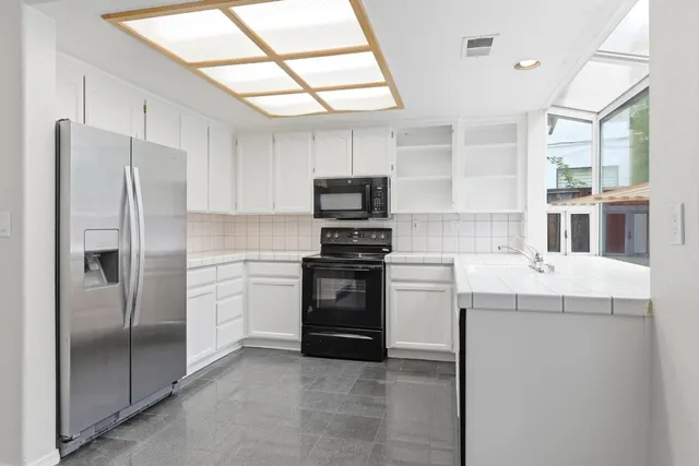 a kitchen with a refrigerator sink and stove