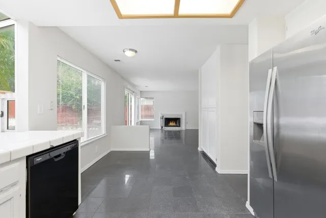 a sink with a large mirror next to a window