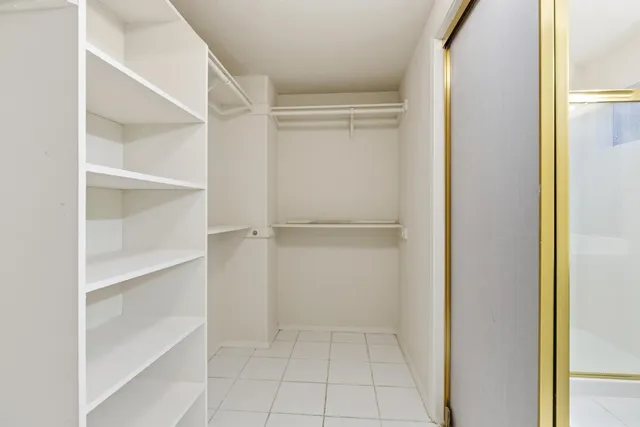 a view of a backyard with couches plants and large trees