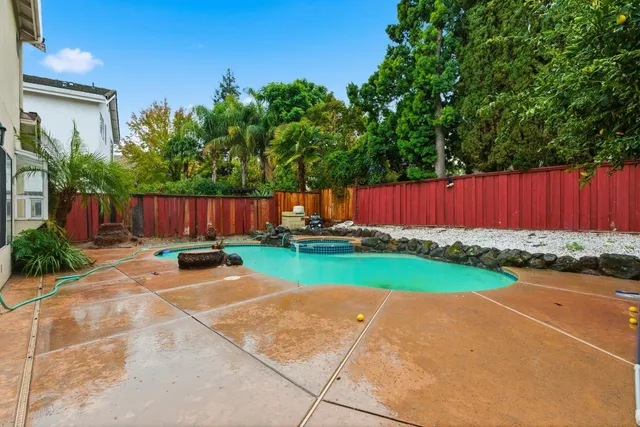 a view of a house with backyard and sitting area