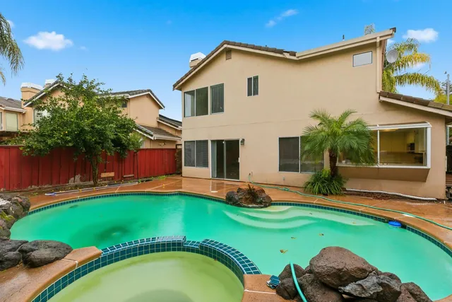 an aerial view of a residential houses with yard