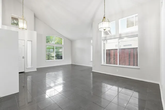 a view of a livingroom with wooden floor and a window