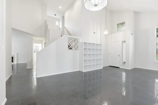 a view of an empty room with wooden floor and entryway