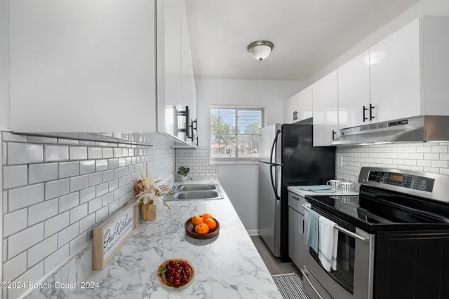 a kitchen with a sink and wooden cabinets