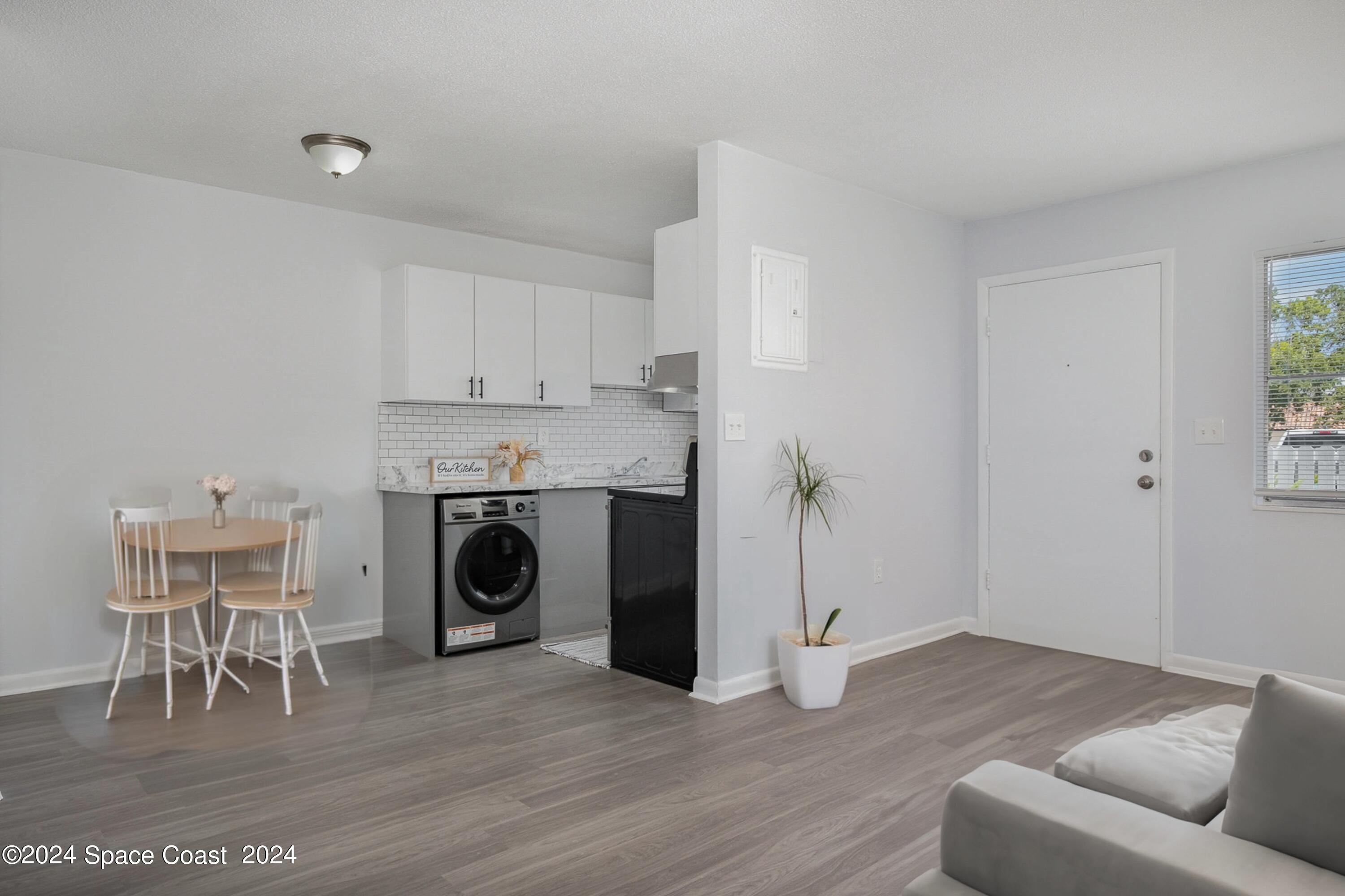 115 Seminole Avenue West, Unit 209 Melbourne, FL 32901 - Photo 5 of 23 a living room with furniture and a fireplace