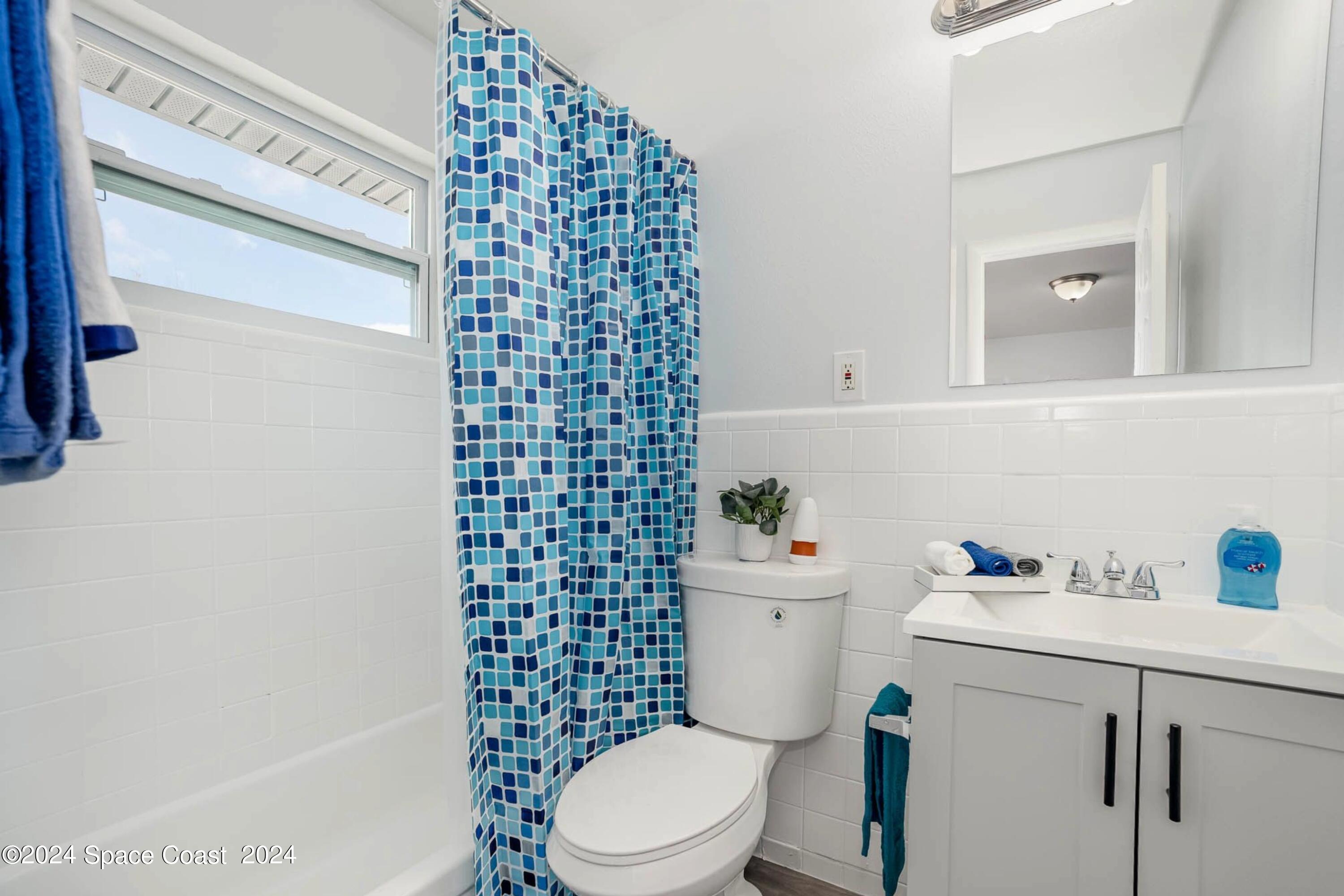 115 Seminole Avenue West, Unit 209 Melbourne, FL 32901 - Photo 8 of 23 a white toilet sitting next to a bathroom sink