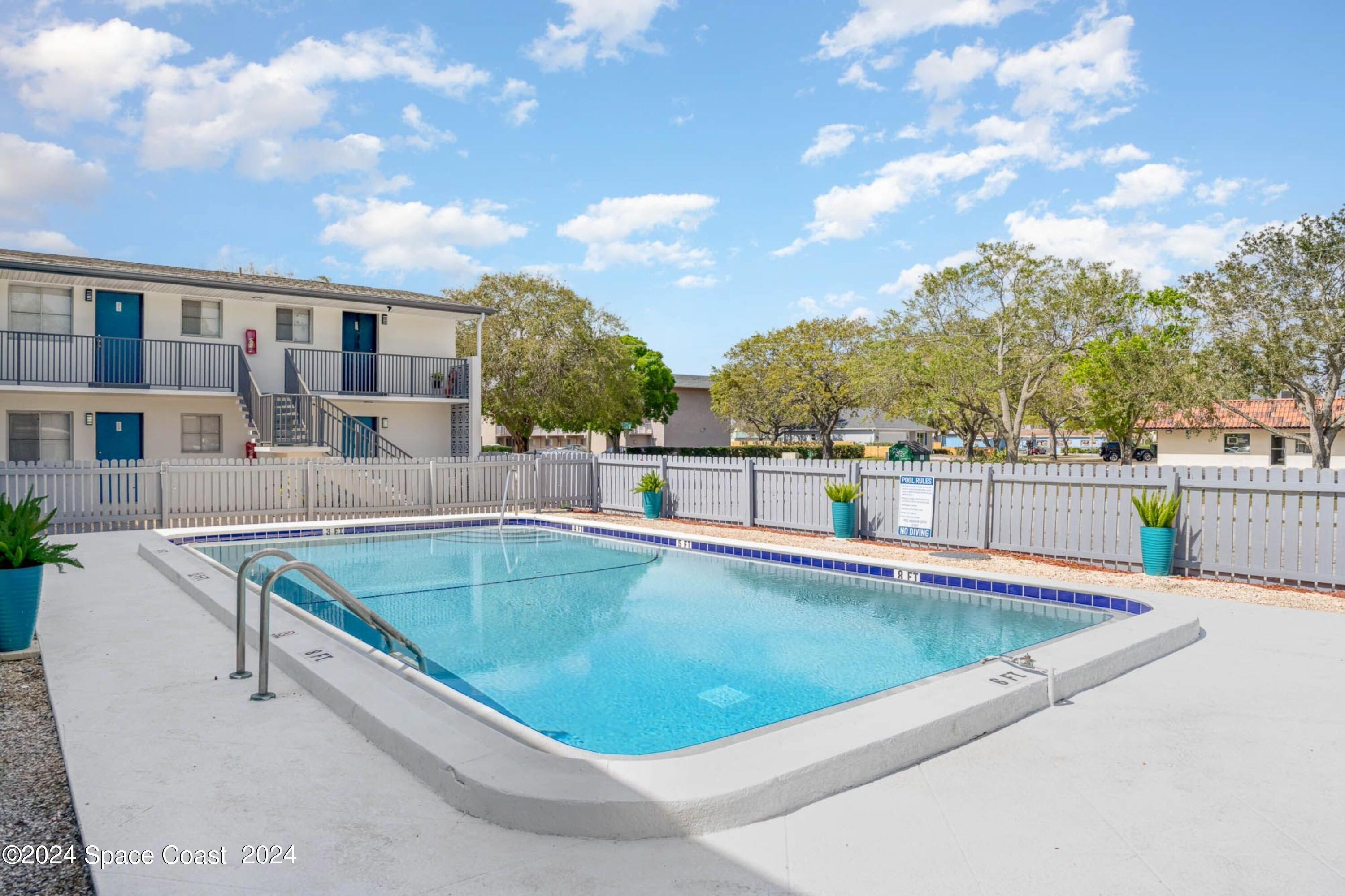115 Seminole Avenue West, Unit 209 Melbourne, FL 32901 - Photo 10 of 23 a view of swimming pool with a lounge chair