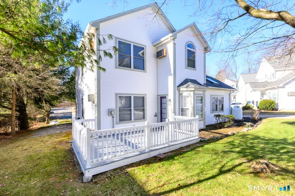 a view of a house with backyard and porch