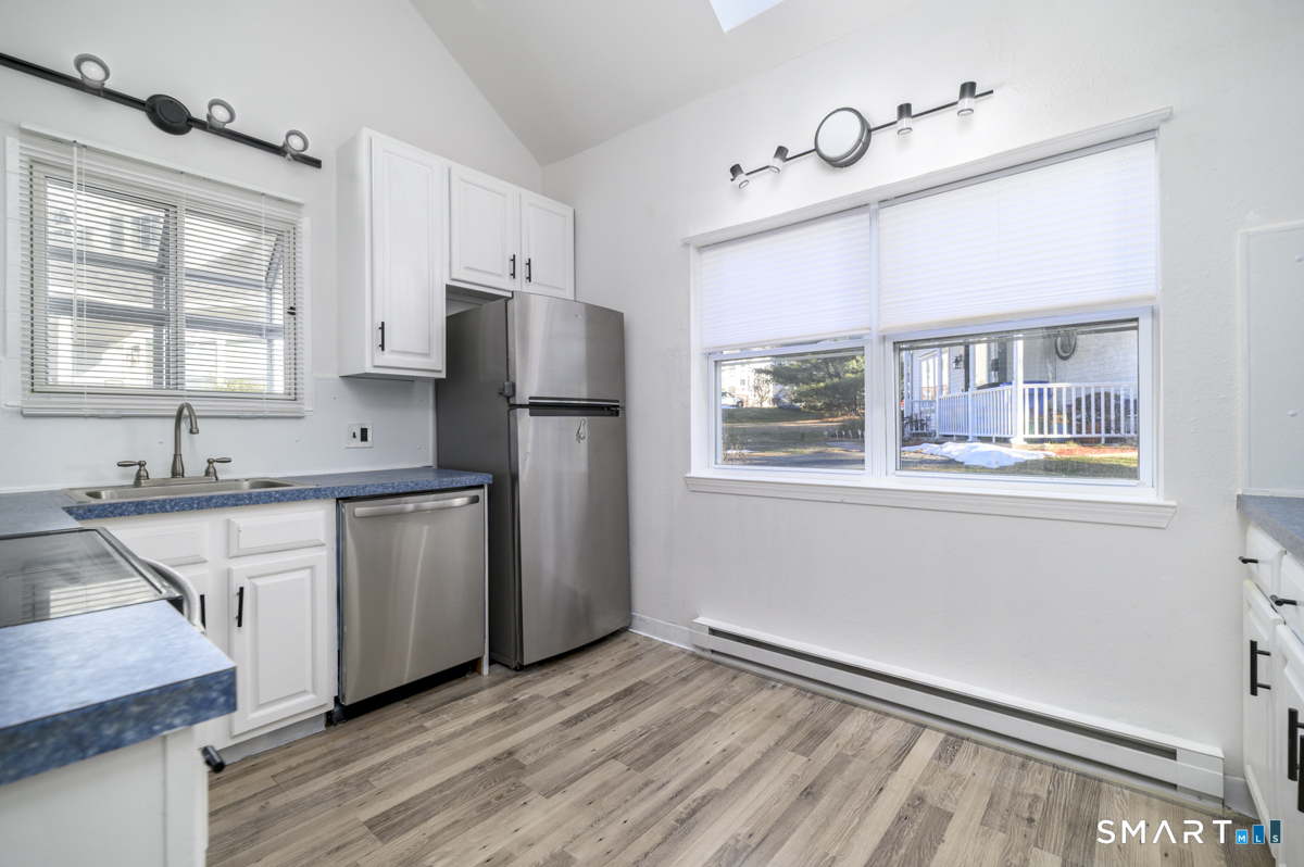 905 Oronoke Road, Unit 13 Waterbury, CT 06708 - Photo 11 of 28 a kitchen with a refrigerator a sink and dishwasher with wooden floor