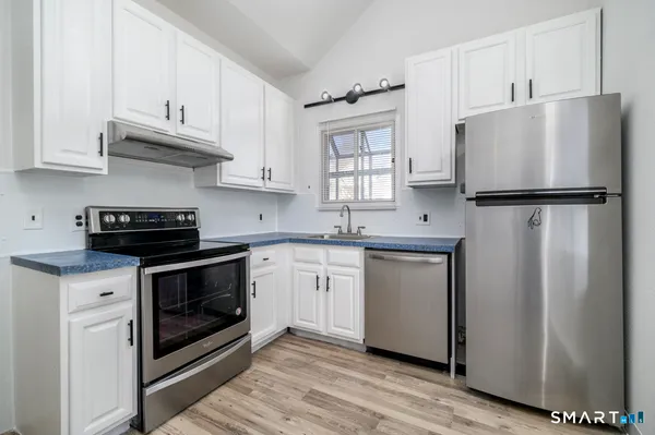 a white refrigerator freezer sitting inside of a kitchen