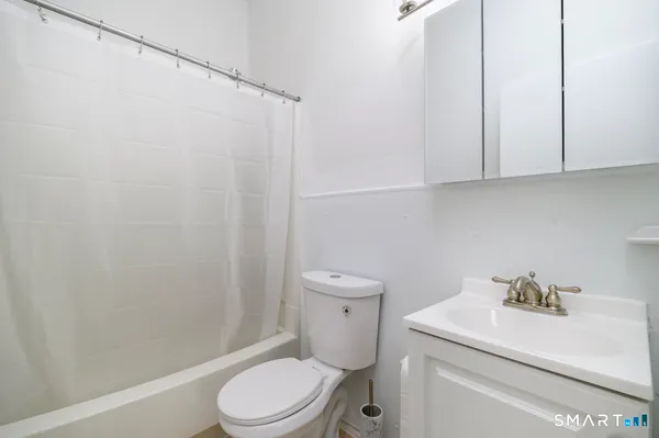a white toilet sitting next to a bathroom sink
