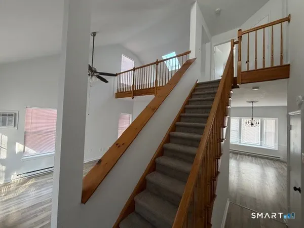 a view of entryway and hall with wooden floor