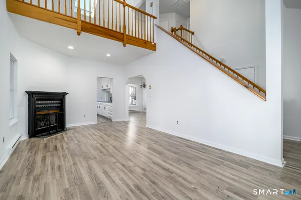 a view of empty room with wooden floor