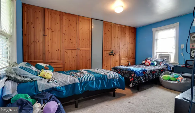 a bedroom with bed and a window